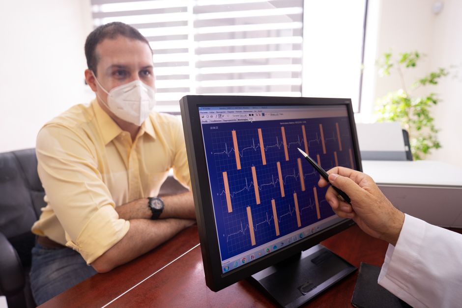 Cardiologist analysing an atrial fibrillation ECG trace on a heart monitor