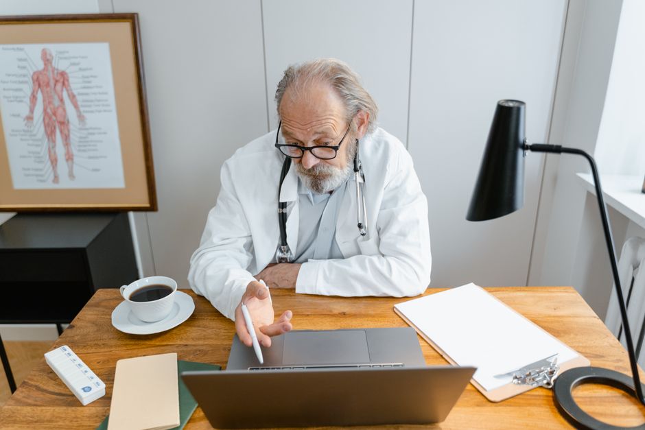 Healthcare professional studying the atrial fibrillation diploma course online from a laptop